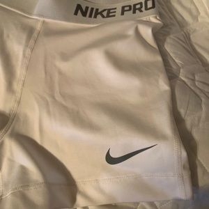 White and grey Nike pro shorts.